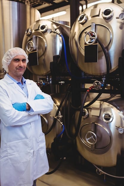 A pharmaceutical manufacturing plant in Brazil, with bioreactors and fermentation tanks being monitored by technicians. The scene highlights the biotechnological processes used in producing biopharmaceuticals.
