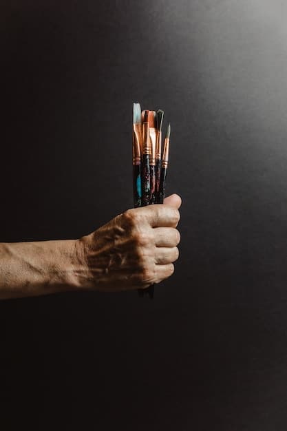 A close-up of a painter's hands holding a brush, with a half-finished AI-generated artwork displayed on a nearby screen. The scene highlights the tension between traditional artistry and the encroaching presence of artificial intelligence. The painter's face shows a mix of curiosity and concern.