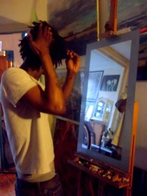 A brightly lit art studio where a Brazilian artist is collaborating with an AI program on a large digital canvas. The screen shows a complex, evolving artwork, and the artist is using a stylus to refine the AI's suggestions. The studio is filled with traditional art supplies, creating a blend of old and new technologies.