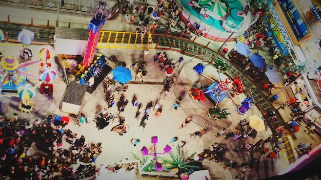 An aerial view of a vibrant Bumba Meu Boi festival in Maranhão, Brazil. The image captures the colorful costumes, elaborate bull floats, and the joyous crowd participating in the dance, with traditional music playing in the background.