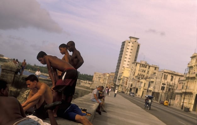 A still from a Hollywood movie set in Rio de Janeiro, showing a stereotypical depiction of a favela with exaggerated poverty and violence.