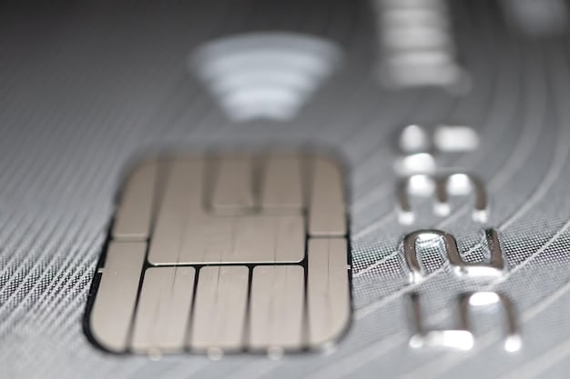 Close-up of a credit card with a stack of bills in the blurred background. Focus on the microchip of the card and the embossed numbers.